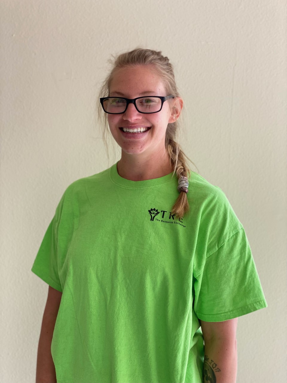 woman wearing green shirt smiling at the viewer