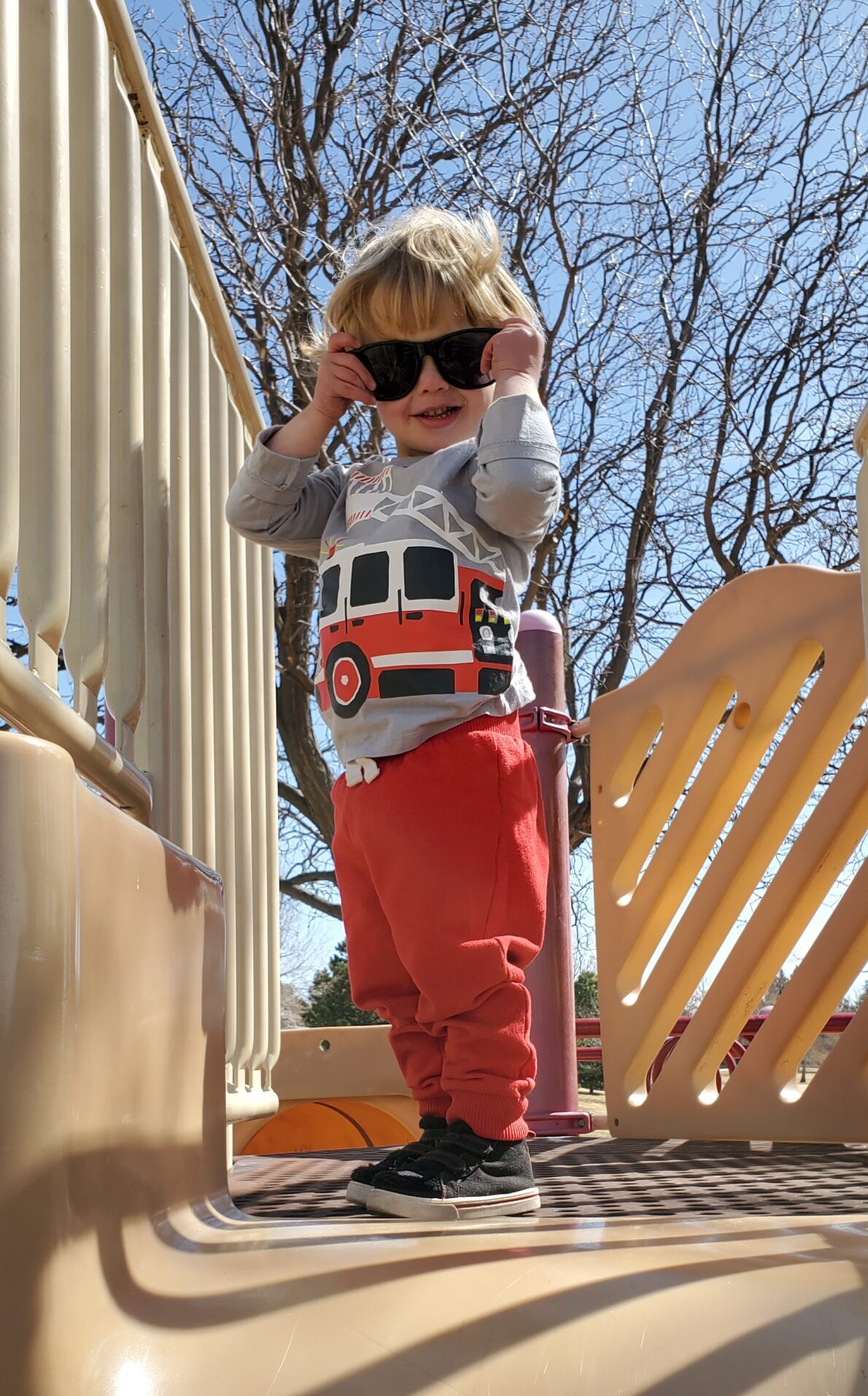 toddler wearing sunglasses standing outside