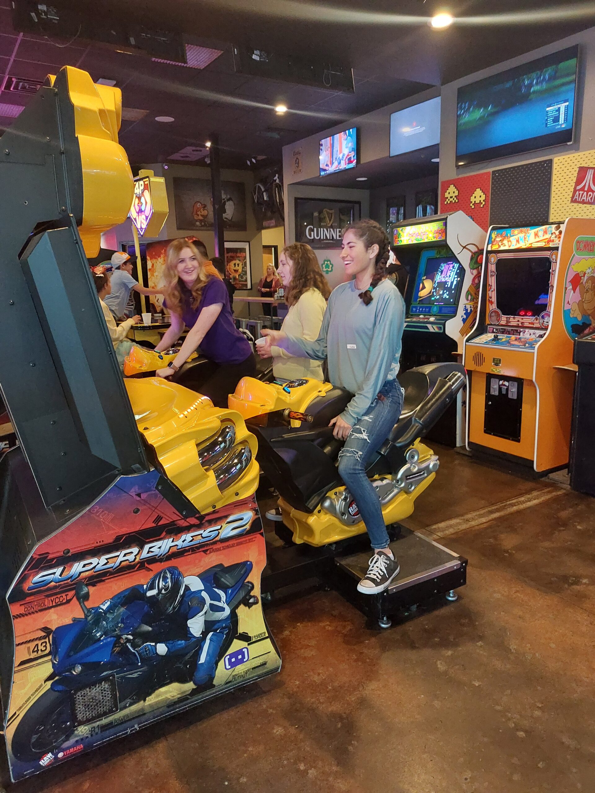 teen girls play games in an arcade