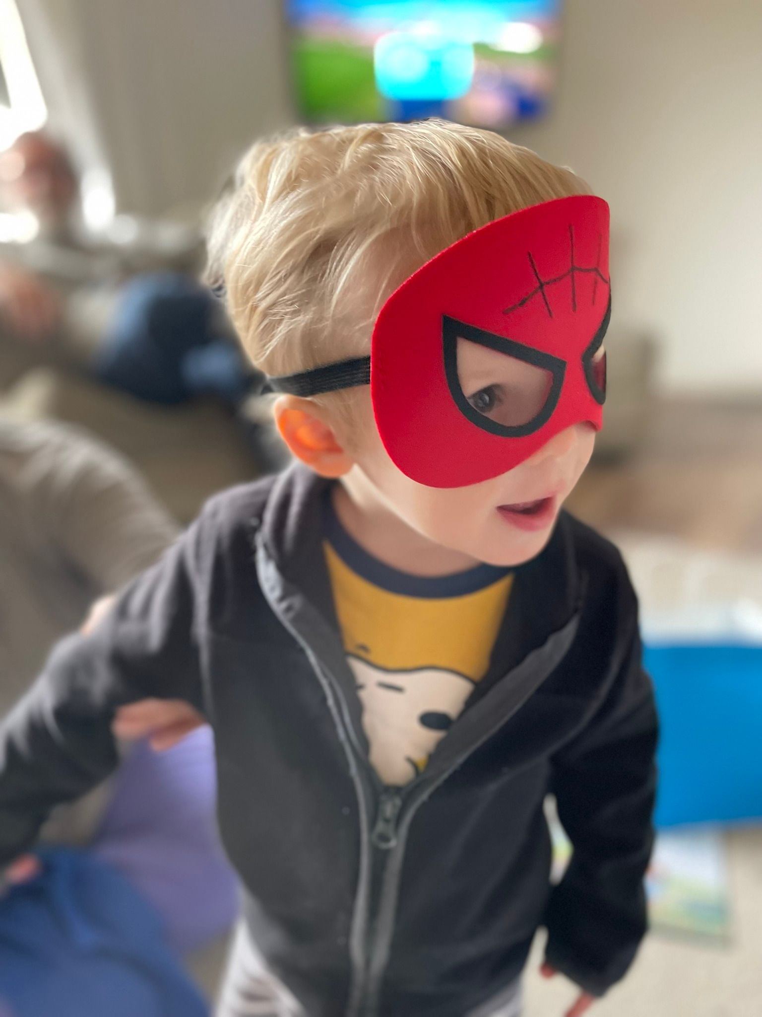 toddler wearing a spiderman mask