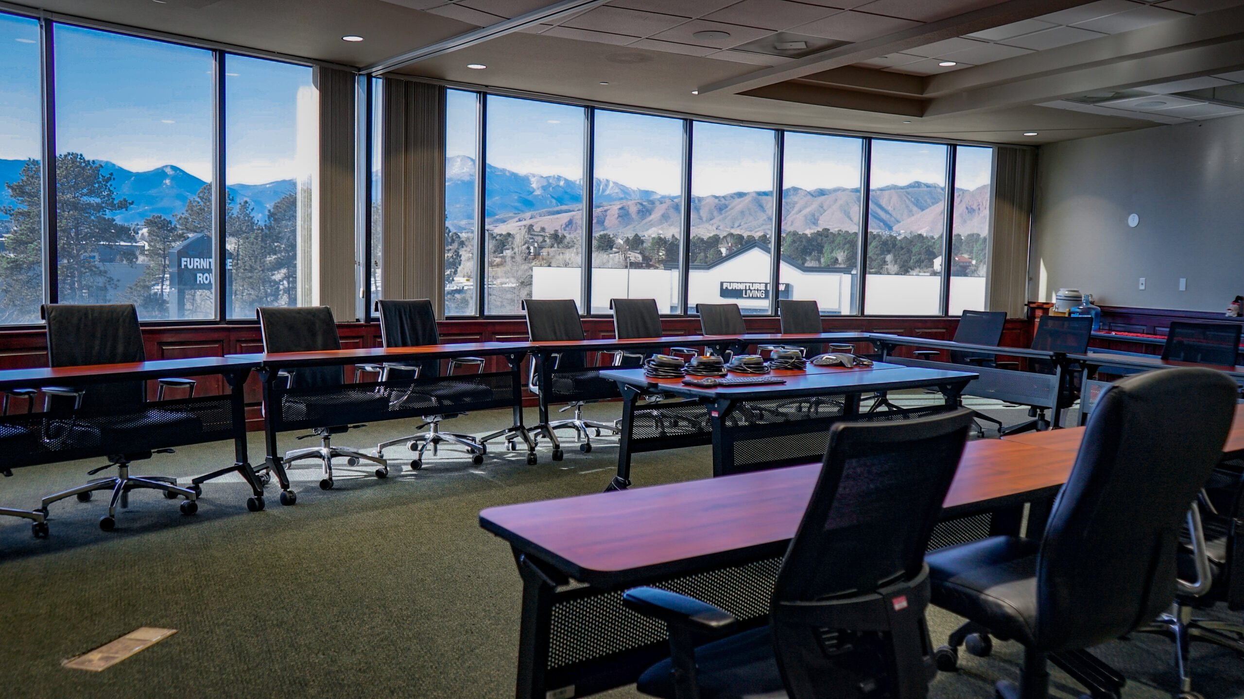 interior of a conference room looking west towards snow-covered mountains